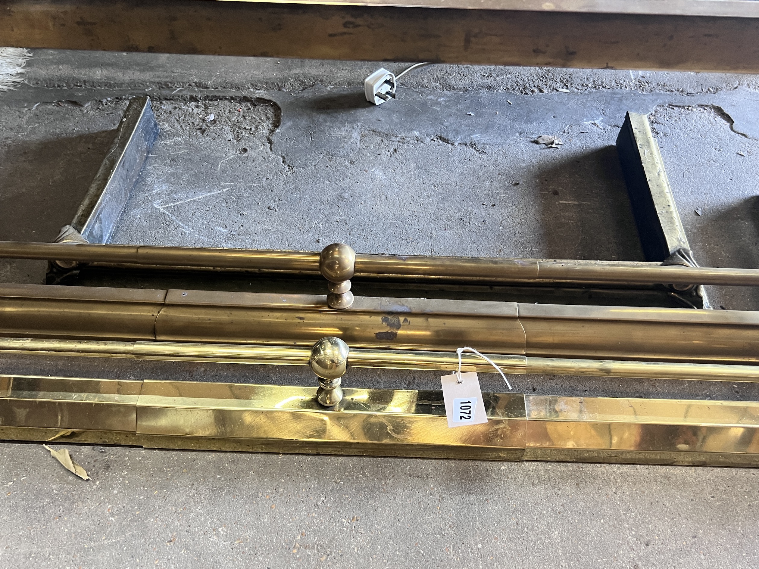 Two Victorian style telescopic brass fenders and a smaller fire curb